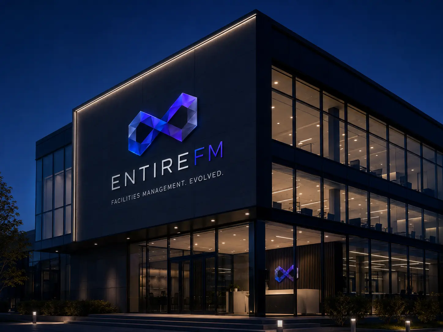 EntireFM branded signage on a modern commercial building exterior at dusk