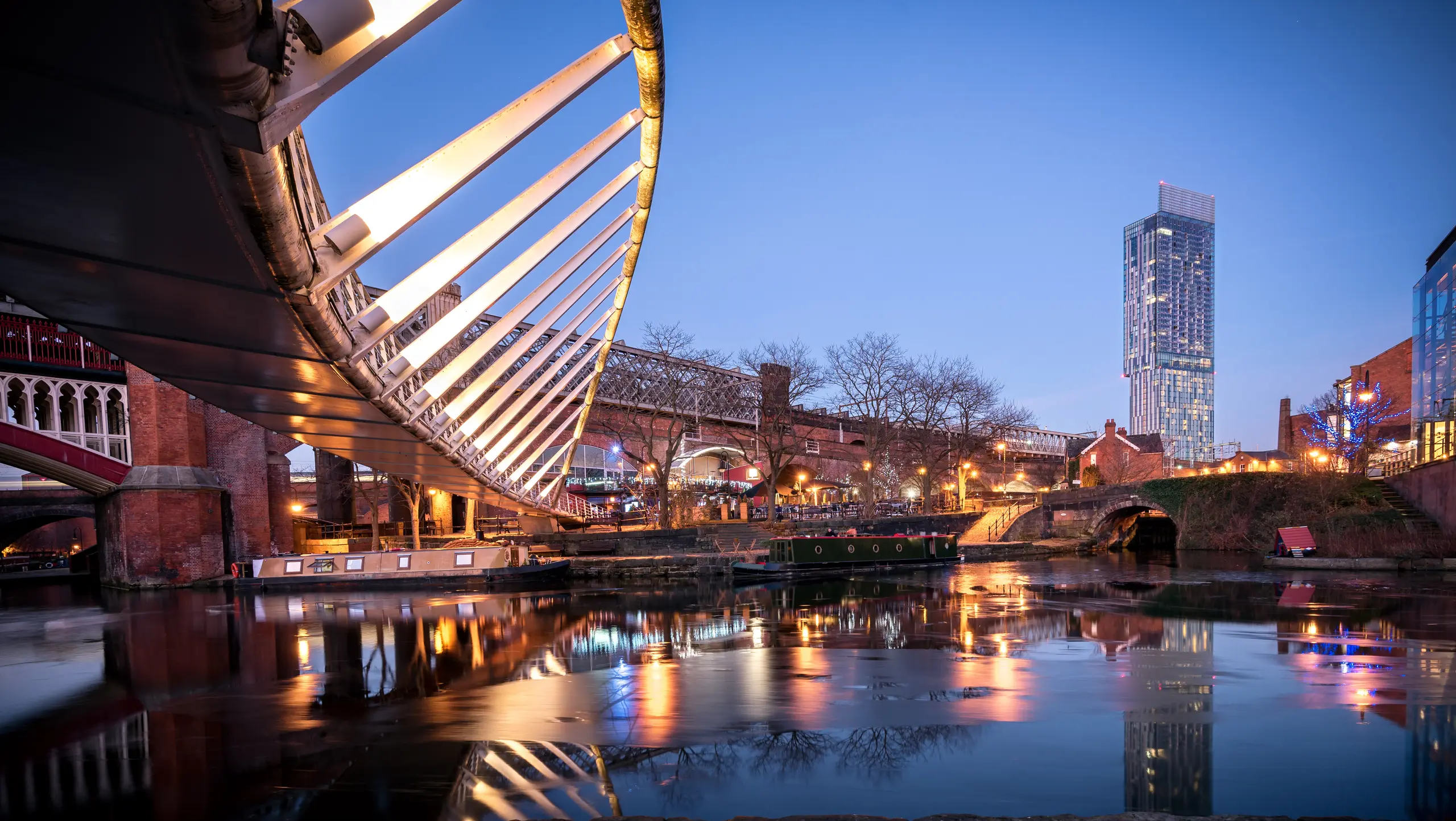 Manchester Castlefield basin at night, with the Beetham Tower behind