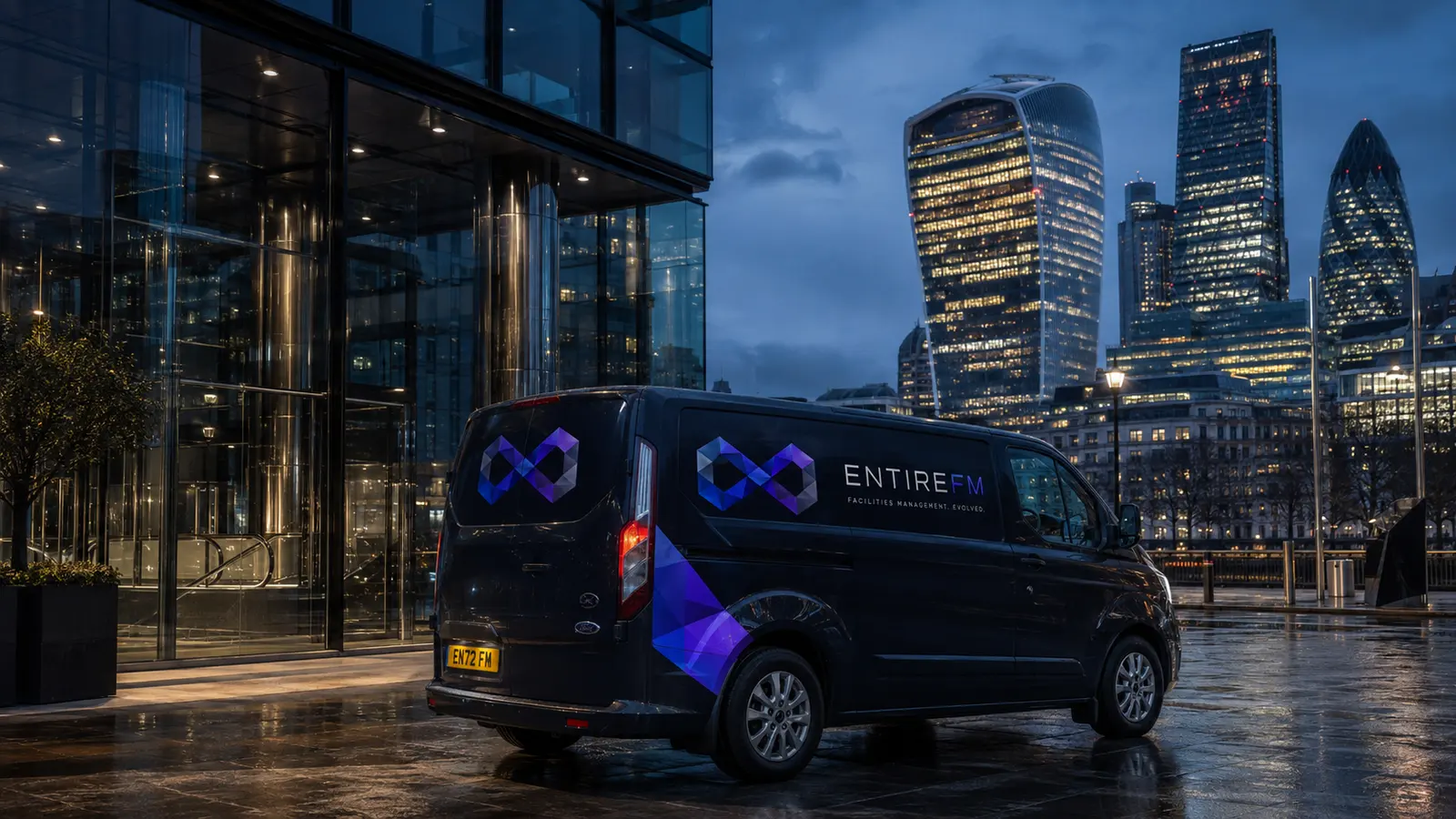 EntireFM facilities management van on a City of London street at dusk, with the Gherkin behind